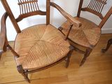 two wooden chairs sitting next to each other on a hard wood floor