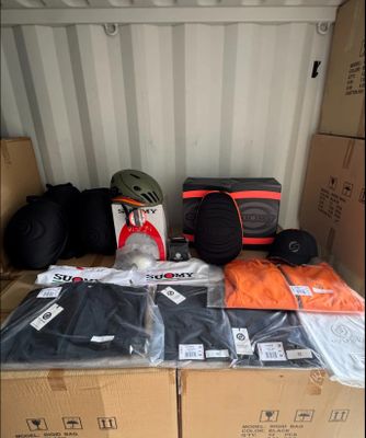 many bags of luggage sitting on top of a cardboard box