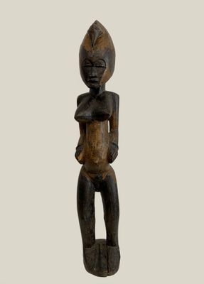 an image of a wooden statue of a woman holding a baby