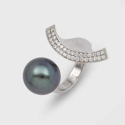a black pearl and diamond ring on a white background