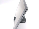 a tablet computer sitting on a stand on a white surface