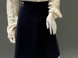 an image of a mannequin wearing a white blouse and black skirt