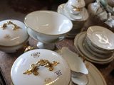 a table with a lot of dishes and bowls on it