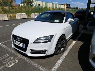 a white car parked in a parking lot next to other cars
