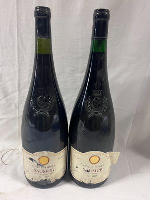 two bottles of wine sitting next to each other on a table