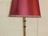 a lamp that has a red shade on top of it
