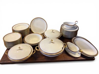 many plates and bowls on a tray on the table