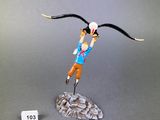 figurine of a man flying with a bird on his head