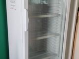 an image of a refrigerator in a room with a green wall