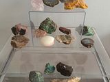a clear glass table with rocks and eggs on it