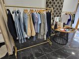 a clothing rack with clothes on it in a room
