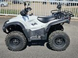 an image of a white four wheeler atv parked in a parking lot