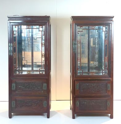two wooden cabinets with glass doors on each of them
