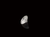 a close up of a white diamond on a black surface