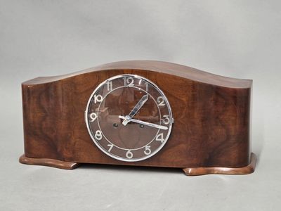 a wooden clock that is sitting on a table