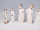five figurines of people standing in a line