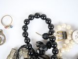many different types of jewelry on a white surface