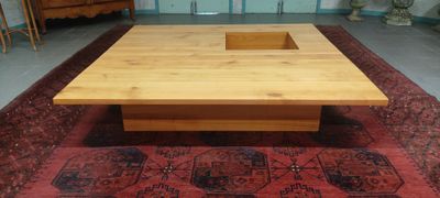 a wooden coffee table with a drawer on top of it