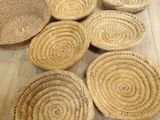 six wicker baskets sitting on top of a wooden table