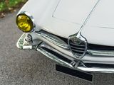 a close up of a white car parked on the side of the road