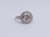 a close up of a diamond ring on a white surface