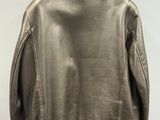 the back of a brown leather jacket hanging on a hanger