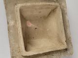a small square bowl sitting on a white surface