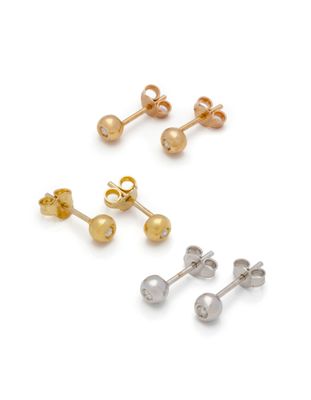 three pairs of gold and silver stud earrings on a white background