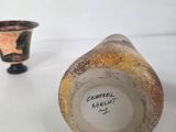 two vases that are sitting on a table