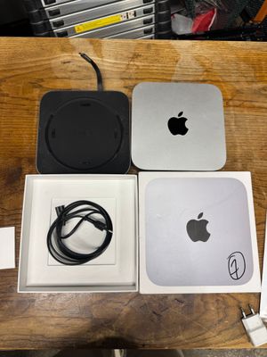 a box with an apple computer and a charger on it