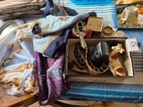 a box full of items on a bed with a blue and white blanket