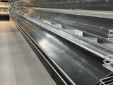 many empty shelves in a store with no people inside
