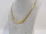a gold chain necklace on a mannequin neck