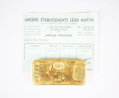 a piece of gold on a piece of paper next to a ticket