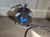 a blue and black electrical cord plugged into a wall
