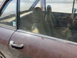 two people sitting in the back seat of a car