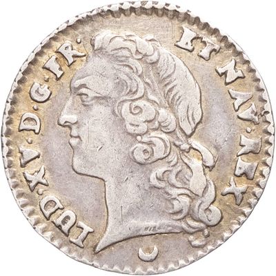 gros plan d'une pièce de monnaie sur laquelle figure une tête de femme