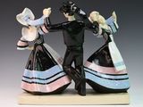 two figurines of a man and a woman dancing