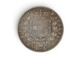 a close up of a coin on a white surface