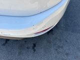 a close up of a car ' s rear bumper with scratches on it