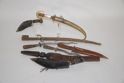 many different types of knives on a white surface