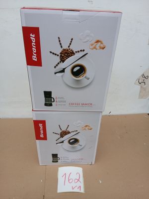 two boxes of coffee on the floor next to each other