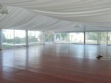 a large open room with a lot of windows and a wooden floor