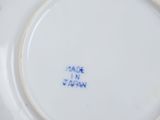 a white plate with blue writing on it on a table