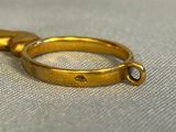 a pair of gold rings that are on top of each other