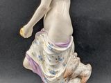 an image of a figurine of a man holding a tennis racket