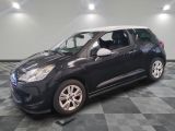 the small black car is parked on a checkered tile floor