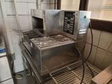 an image of a commercial kitchen with a stove and oven