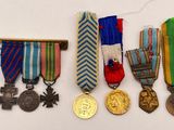 several medals and medals are displayed on a white surface