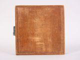 an old book that is sitting on a white surface
